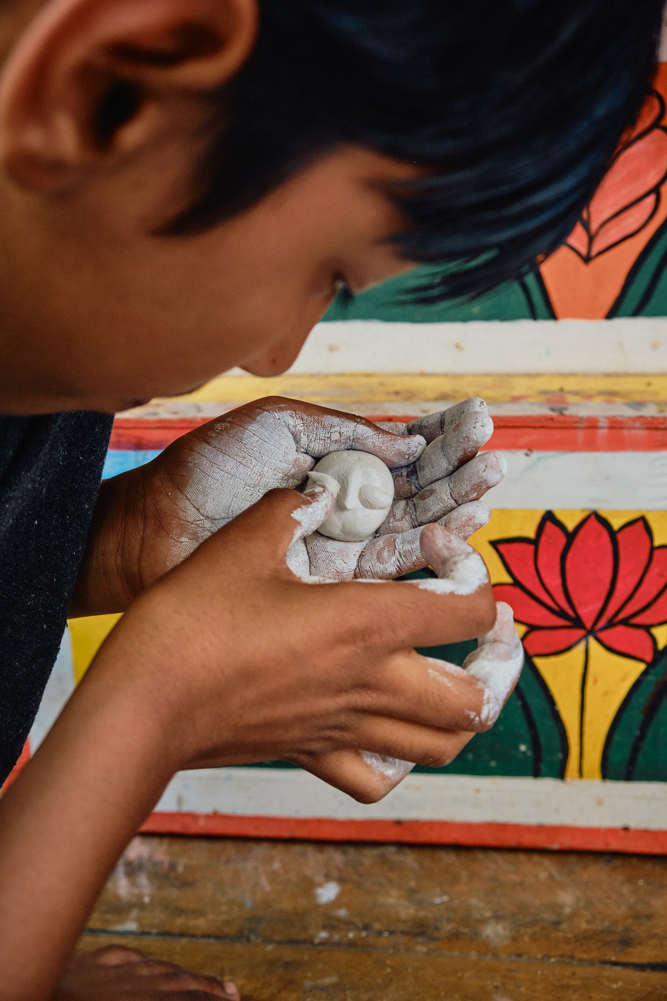 Close-up Unfinished White Clay Sculpture Boy Artist Kolkata Street Documentary Graphic Color Contrast